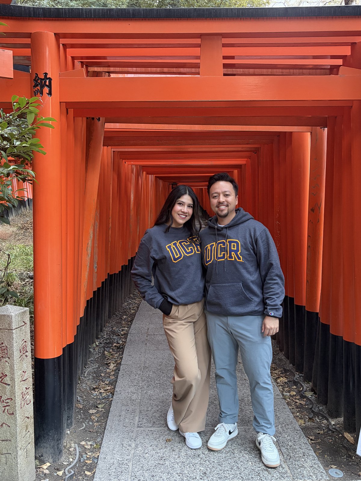 Guadalupe and Harrison in matching sweatshirts under the torii gates at Fushimi Inari