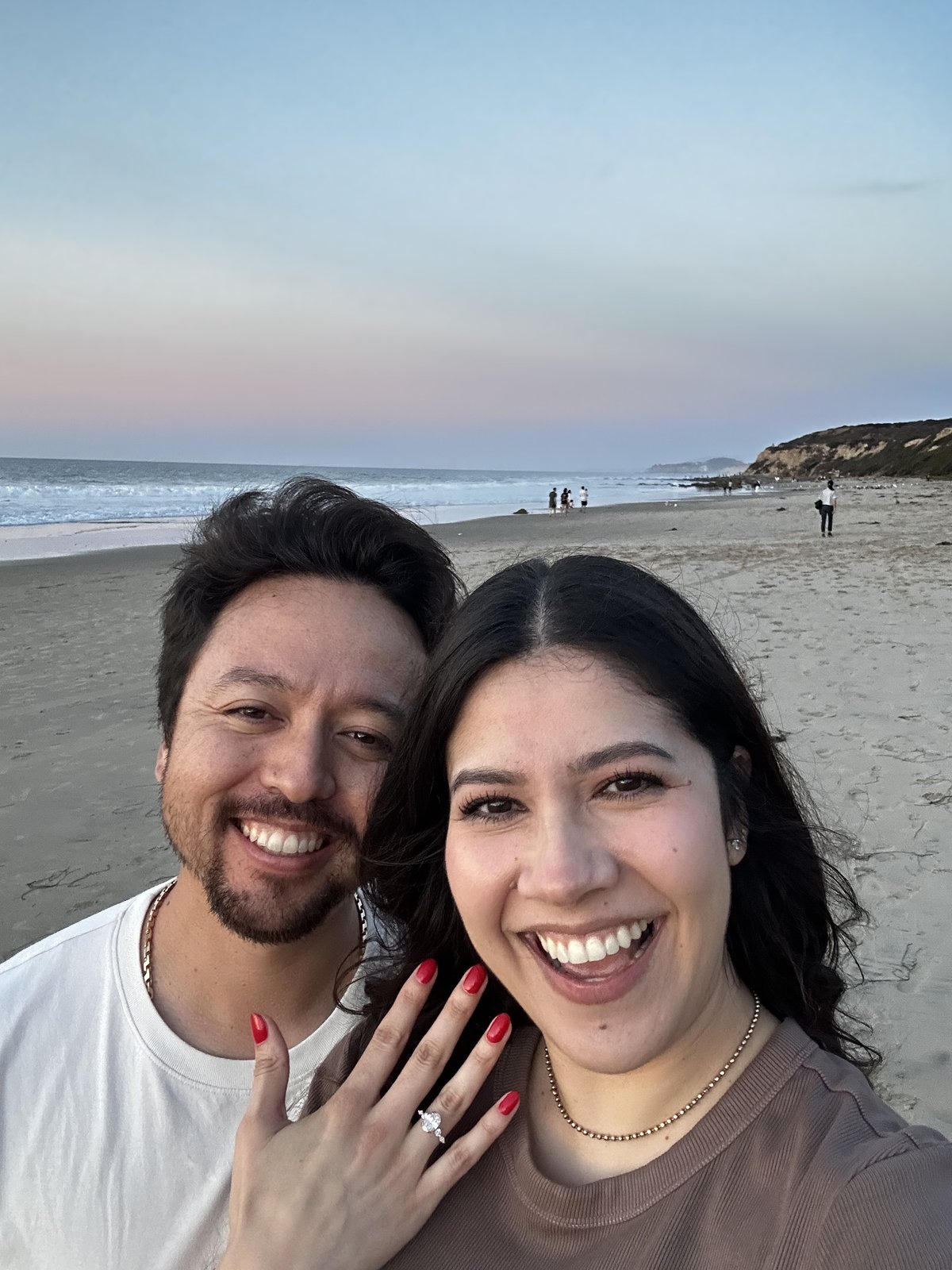 Guadalupe and Harrison smiling together just after the proposal, her ring visible